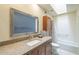 Well-maintained bathroom featuring a granite vanity, framed mirror, and a shower-tub combination at 1021 S Greenfield Rd # 1213, Mesa, AZ 85206
