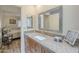 Bathroom with granite countertop, updated fixtures, square mirror and views to an adjacent bedroom at 1021 S Greenfield Rd # 1213, Mesa, AZ 85206