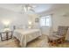 Cozy bedroom featuring a comfortable bed, a rocking chair, and a side table with lamps at 1021 S Greenfield Rd # 1213, Mesa, AZ 85206