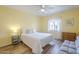 Bedroom with wood flooring, ceiling fan, bright yellow walls, and lots of natural light at 1021 S Greenfield Rd # 1213, Mesa, AZ 85206