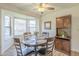 Cozy dining area with a bay window, stylish light fixture, and hardwood flooring at 1021 S Greenfield Rd # 1213, Mesa, AZ 85206