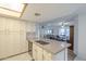 Spacious kitchen with an island, abundant white cabinets, and a view of the dining area at 1021 S Greenfield Rd # 1213, Mesa, AZ 85206