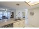 Kitchen island with a double sink, granite countertops, and views to dining and other rooms at 1021 S Greenfield Rd # 1213, Mesa, AZ 85206