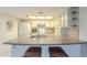 Bright kitchen featuring white cabinetry, a spacious island, and pendant lighting above at 1021 S Greenfield Rd # 1213, Mesa, AZ 85206