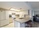 Bright kitchen with white cabinetry, tile backsplash, large island, and stainless appliances at 1021 S Greenfield Rd # 1213, Mesa, AZ 85206