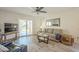 Inviting living room featuring a cozy sofa, a mounted TV, and a sliding door to the outside at 1021 S Greenfield Rd # 1213, Mesa, AZ 85206