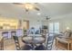 Bright living room with dining area, modern ceiling fans, and access to the kitchen and outdoor patio at 1021 S Greenfield Rd # 1213, Mesa, AZ 85206