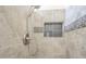Close up of the shower with a shower head, wall tiles, and a built-in shampoo and soap shelf at 1021 S Greenfield Rd # 1213, Mesa, AZ 85206