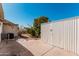 Exterior view of the backyard featuring a shed and mature landscaping at 106 S 74Th St, Mesa, AZ 85208