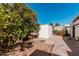 View of the home's backyard area with storage shed and mature citrus trees at 106 S 74Th St, Mesa, AZ 85208