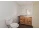Bathroom featuring wood-look vinyl floors, a wood vanity, and a standard toilet at 106 S 74Th St, Mesa, AZ 85208