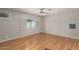Large bedroom with neutral walls, and vinyl flooring with a ceiling fan and a window at 106 S 74Th St, Mesa, AZ 85208