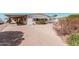 Single-story home with a large carport and xeriscaped front yard at 106 S 74Th St, Mesa, AZ 85208
