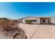Quaint single-story home featuring a covered carport and mature desert landscaping at 106 S 74Th St, Mesa, AZ 85208