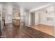 Open-concept living and kitchen area featuring modern vinyl floors and a ceiling fan at 106 S 74Th St, Mesa, AZ 85208