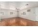 Bright living room featuring wood floors, a ceiling fan, and shuttered windows at 106 S 74Th St, Mesa, AZ 85208