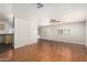 Spacious living room showcases wood floors, a ceiling fan, and seamless transition to the kitchen at 106 S 74Th St, Mesa, AZ 85208