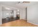 Open-concept living room featuring a ceiling fan, gray wall paint, and vinyl flooring at 106 S 74Th St, Mesa, AZ 85208