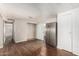 Living room with an open layout, neutral walls, updated vinyl flooring and stainless steel refrigerator at 106 S 74Th St, Mesa, AZ 85208