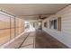 Exterior view of the covered patio area with ceiling fan and shaded awning at 106 S 74Th St, Mesa, AZ 85208