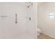 Bright bathroom shower with safety rails, shelving, and updated fixtures at 106 S 74Th St, Mesa, AZ 85208