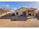 Backyard features a covered patio, a block wall and low maintenance landscaping at 1100 E Canyon Trl, San Tan Valley, AZ 85143