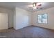 Carpeted bedroom features a ceiling fan, closet, and window at 1100 E Canyon Trl, San Tan Valley, AZ 85143