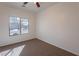 Bright bedroom offers neutral walls and carpet floors, plus natural sunlight through the window at 1100 E Canyon Trl, San Tan Valley, AZ 85143