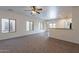 Bright living room with abundant natural light, neutral walls, and open layout to kitchen at 1100 E Canyon Trl, San Tan Valley, AZ 85143