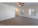 Spacious living room with neutral walls, soft carpeting, and ample space for furniture arrangement at 1100 E Canyon Trl, San Tan Valley, AZ 85143