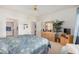 Bright bedroom features a ceiling fan, a dresser with a mirror, and easy access to the ensuite bathroom at 11069 E Kilarea Ave # 198, Mesa, AZ 85209