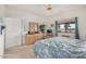 Comfortable bedroom features a ceiling fan, a dresser with a mirror, and a window with blue drapes at 11069 E Kilarea Ave # 198, Mesa, AZ 85209
