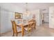 Bright dining room featuring a traditional wooden dining set and a stylish chandelier, creating an inviting atmosphere at 11069 E Kilarea Ave # 198, Mesa, AZ 85209