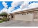 Single-story home featuring a wide driveway, stone pillar accents, and desert landscaping, located in a quiet neighborhood at 11069 E Kilarea Ave # 198, Mesa, AZ 85209