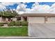 Charming single-story home with a well-manicured lawn, stone accents, and a spacious three-car garage at 11069 E Kilarea Ave # 198, Mesa, AZ 85209