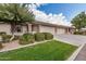 Lovely single-story home with a well-maintained lawn, attractive desert landscaping, and an attached three-car garage at 11069 E Kilarea Ave # 198, Mesa, AZ 85209