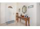 Inviting foyer featuring a tiled floor, decorative table with mirror, and a bright front door at 11069 E Kilarea Ave # 198, Mesa, AZ 85209