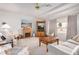 Bright living room with a fireplace, beamed ceilings, a large window, and comfortable seating at 11069 E Kilarea Ave # 198, Mesa, AZ 85209