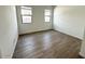 Bedroom featuring wood-look tile floors, white walls, and large windows at 11426 E Utopia Ave, Mesa, AZ 85212