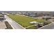Aerial perspective of a community park featuring a large grassy field, covered picnic areas, and landscaping at 11426 E Utopia Ave, Mesa, AZ 85212