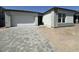 New construction with a large driveway and a two car garage at 11426 E Utopia Ave, Mesa, AZ 85212
