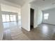 Hallway with wood-look floors leads into a living room with sliding glass doors at 11426 E Utopia Ave, Mesa, AZ 85212