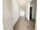 Hallway featuring wood-look tile floors, leading to a bright living space at 11426 E Utopia Ave, Mesa, AZ 85212