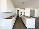 Bright, spacious kitchen features white cabinets and modern design, awaiting appliances and countertops at 11426 E Utopia Ave, Mesa, AZ 85212