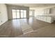 Open-concept living area featuring wood-look flooring, large windows, and access to the kitchen at 11426 E Utopia Ave, Mesa, AZ 85212