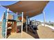 Community playground featuring a shaded play structure with slides, climbing features and wood chip surface at 11426 E Utopia Ave, Mesa, AZ 85212