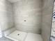 Walk-in shower features modern tile, built-in bench, and sleek design, offering a spa-like experience at 11426 E Utopia Ave, Mesa, AZ 85212