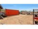 Large dirt backyard with storage container, shed, and dog house at 11652 N 49Th Dr, Glendale, AZ 85304