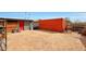 Spacious dirt backyard with storage container and red entry door at 11652 N 49Th Dr, Glendale, AZ 85304