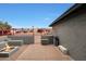 Backyard outdoor living space with steps, gray pavers, a red fence and a fire pit at 11652 N 49Th Dr, Glendale, AZ 85304